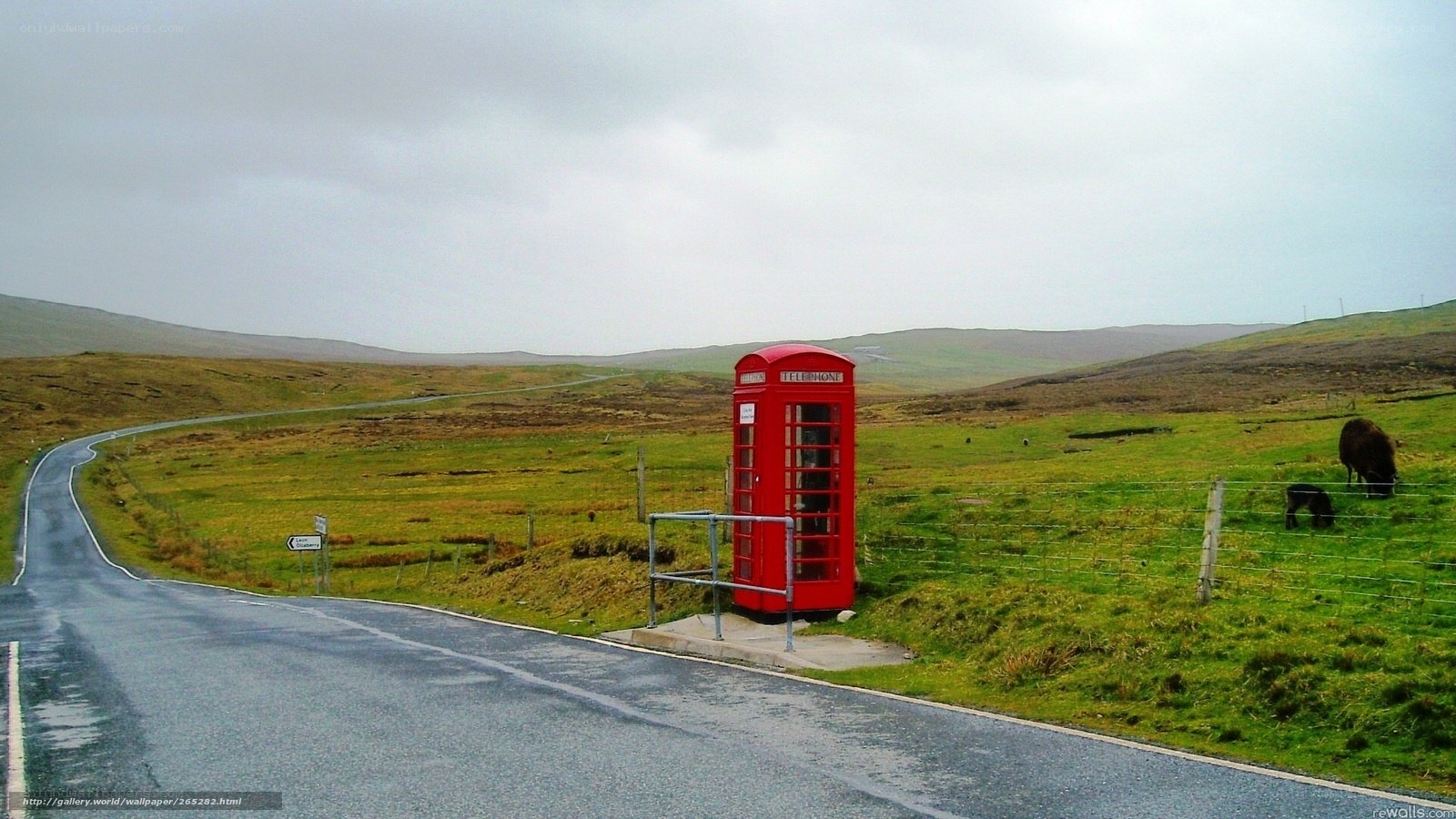 Red phone box on rural road