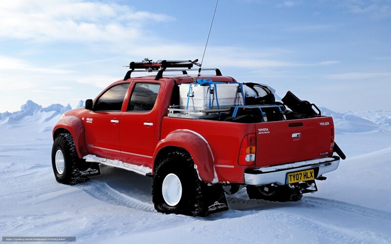 Red pickup in snowy landscape