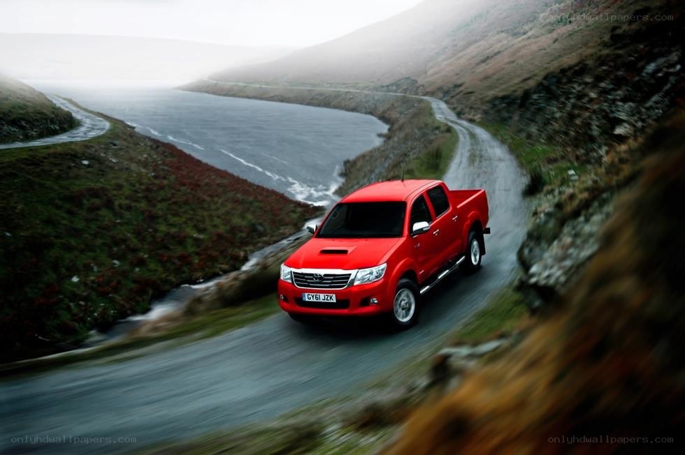 Red pickup on winding road
