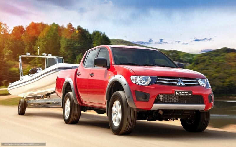 Red pickup towing boat