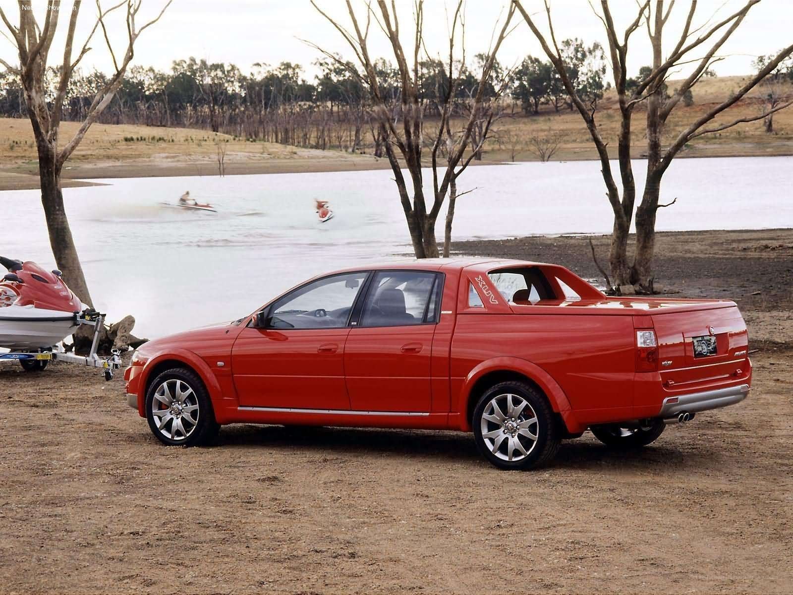 Red pickup truck by lake