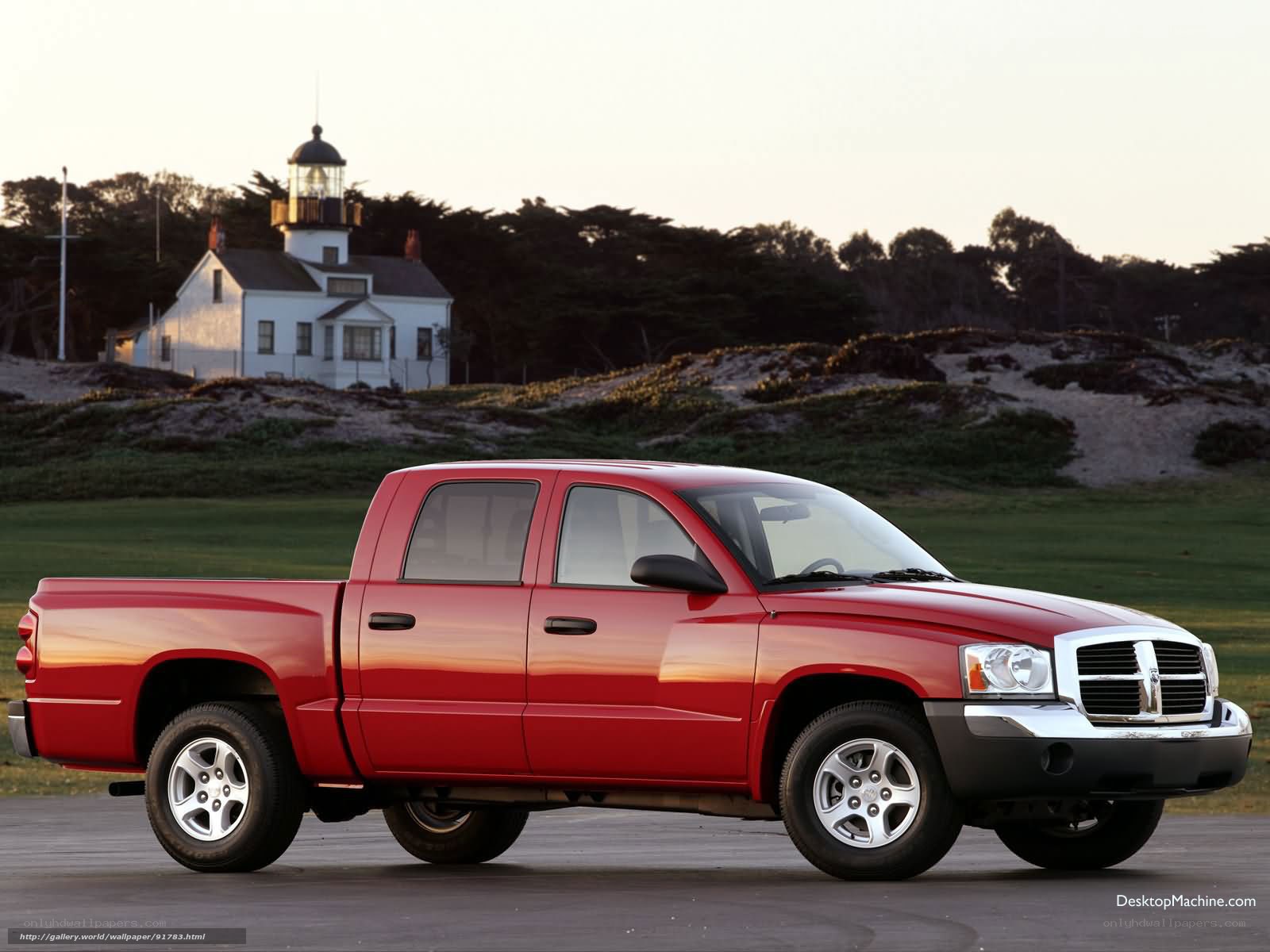 Red pickup truck by lighthouse