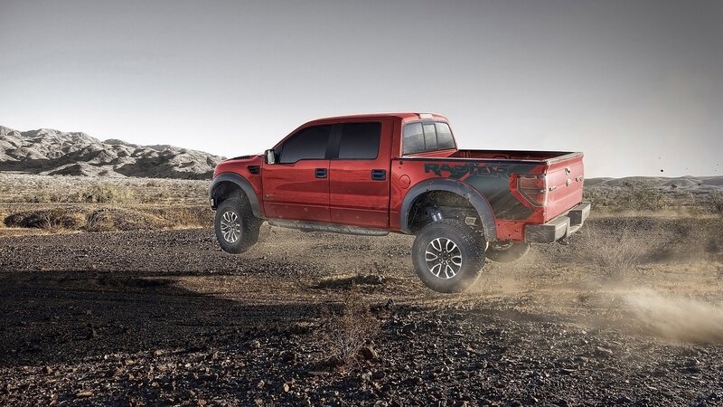 Red pickup truck in desert