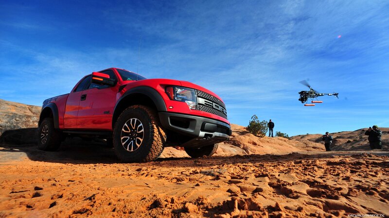 Red pickup truck in desert