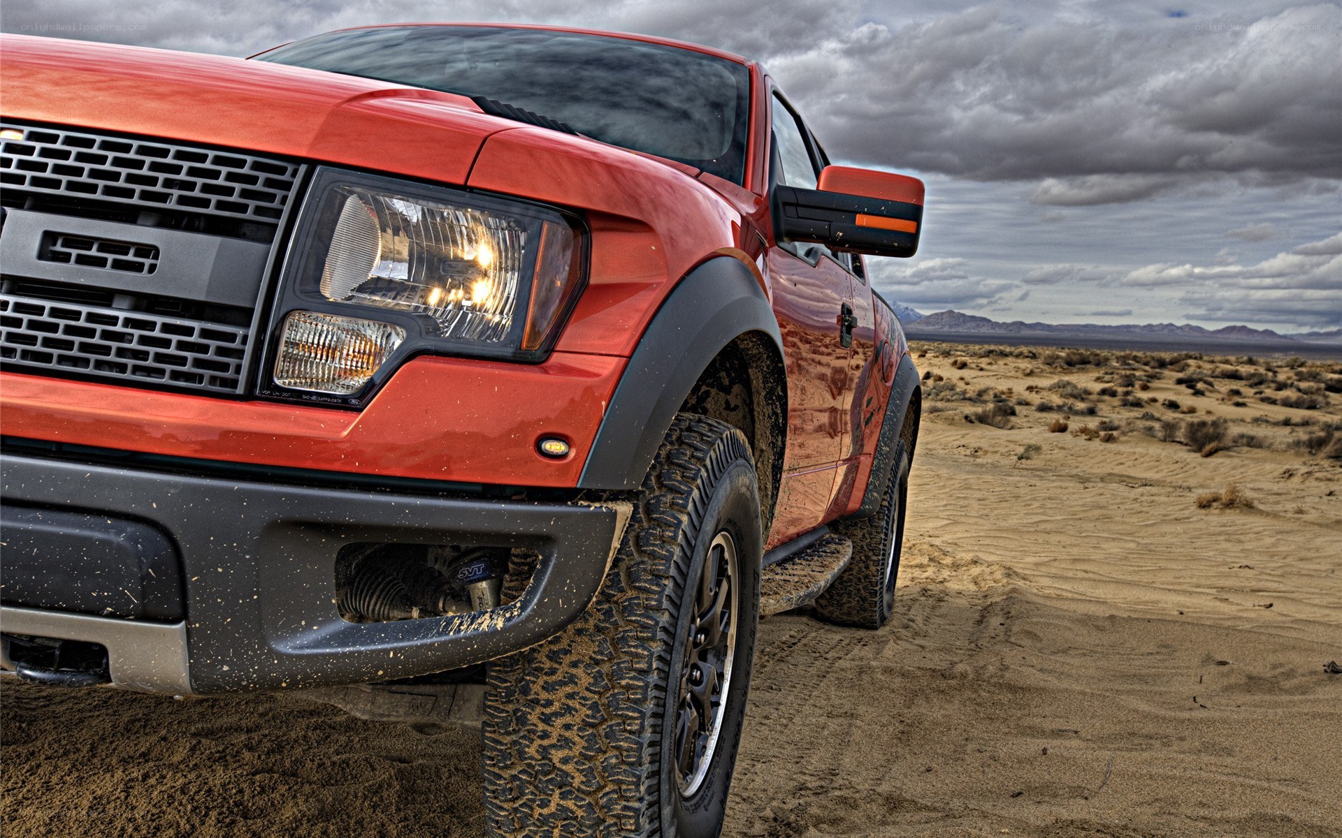 Red pickup truck in desert