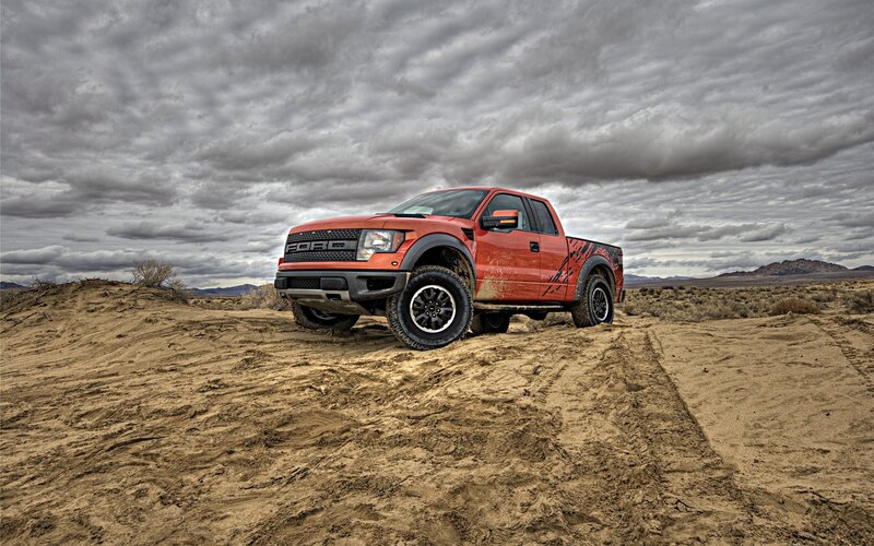 Red pickup truck in desert