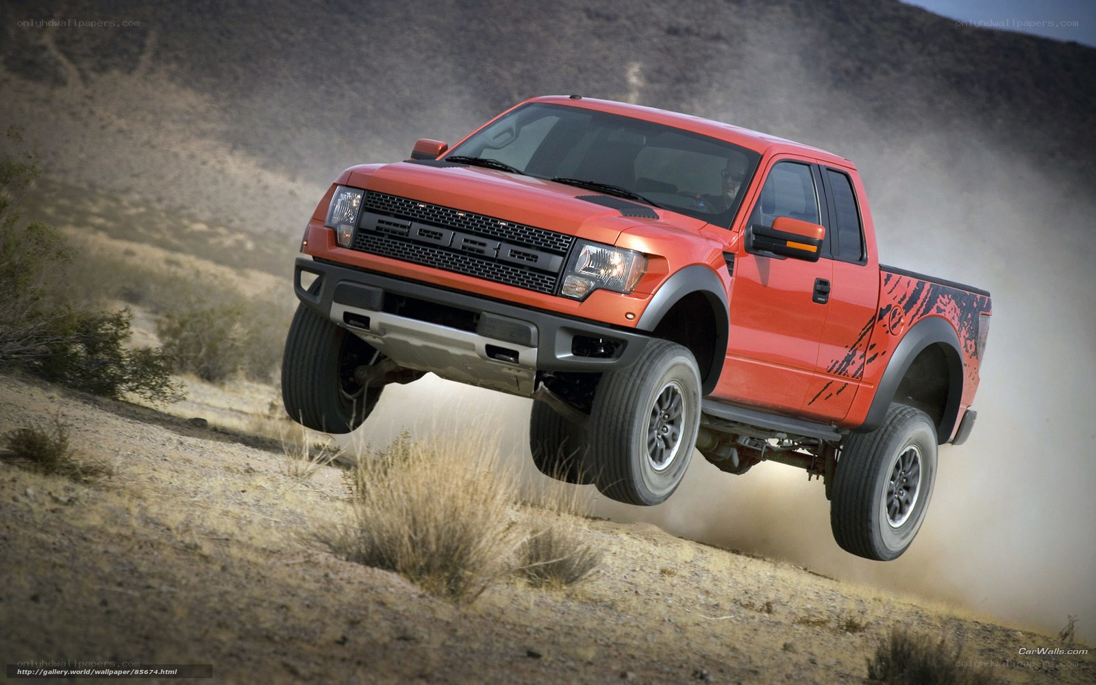 Red pickup truck in desert