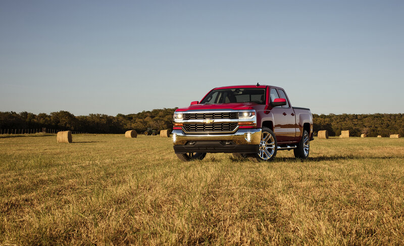 Red pickup truck in field