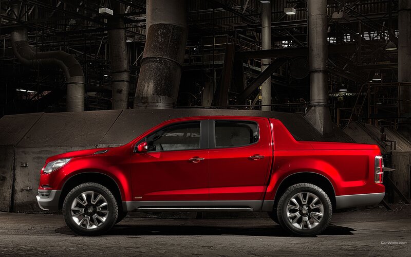 Red pickup truck in industrial setting