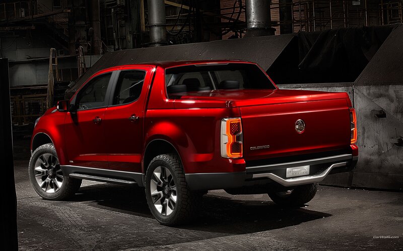 Red pickup truck in industrial setting