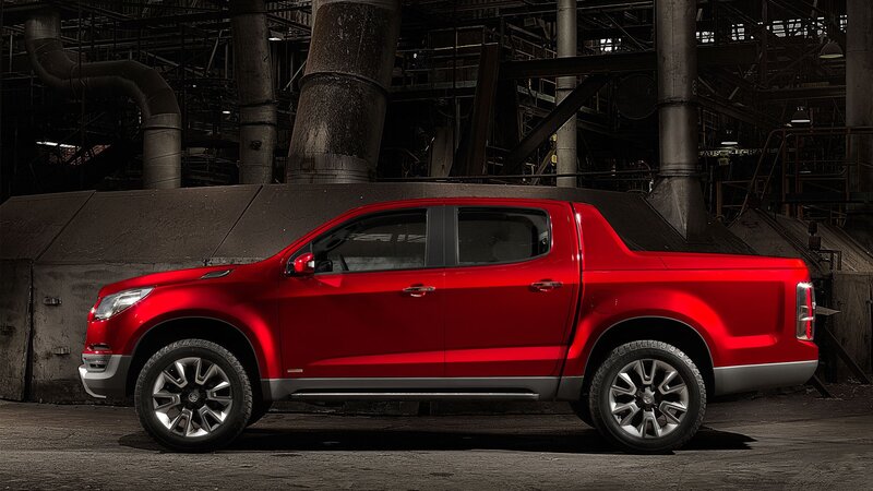 Red pickup truck in industrial setting