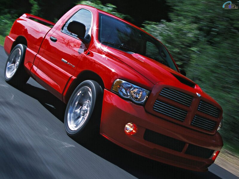 red pickup truck in motion
