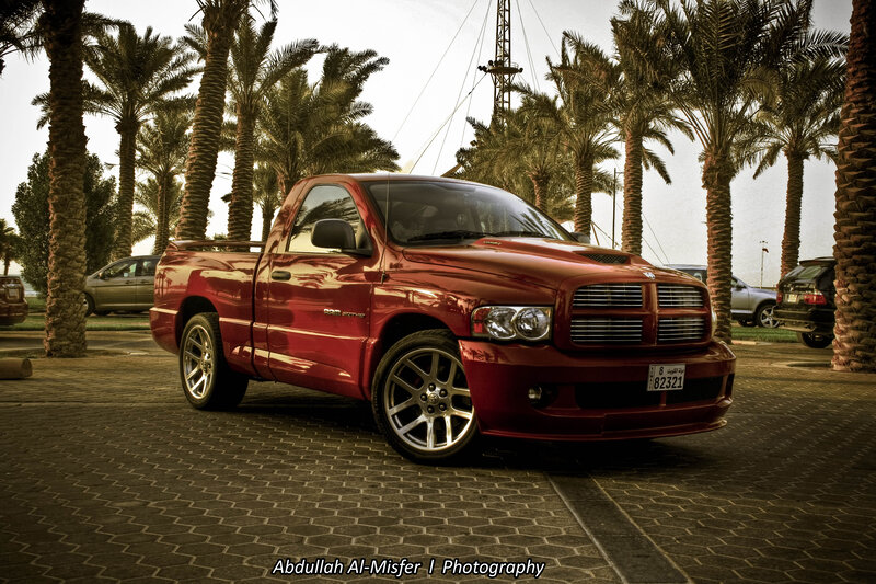 Red pickup truck in palm grove