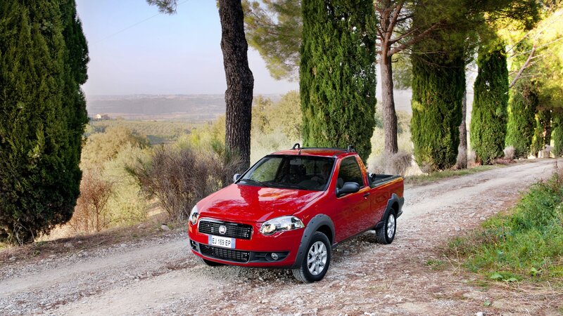 Red pickup truck on a country road