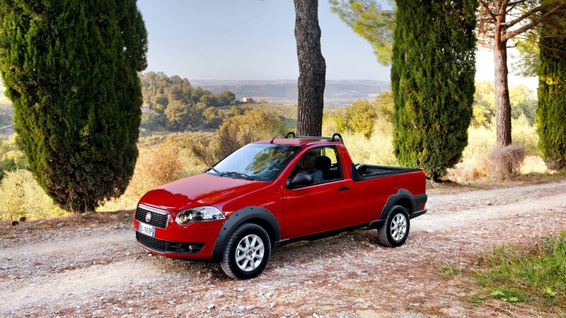 Red pickup truck on a dirt road