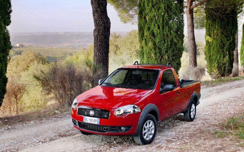 Red pickup truck on a dirt road