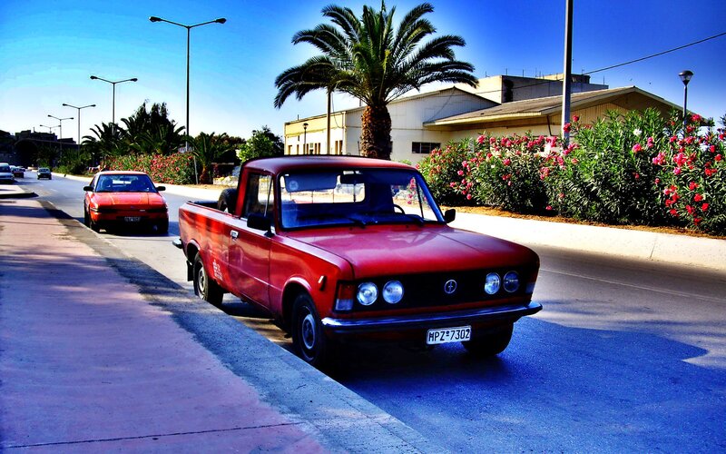 Red pickup truck on a sunny street