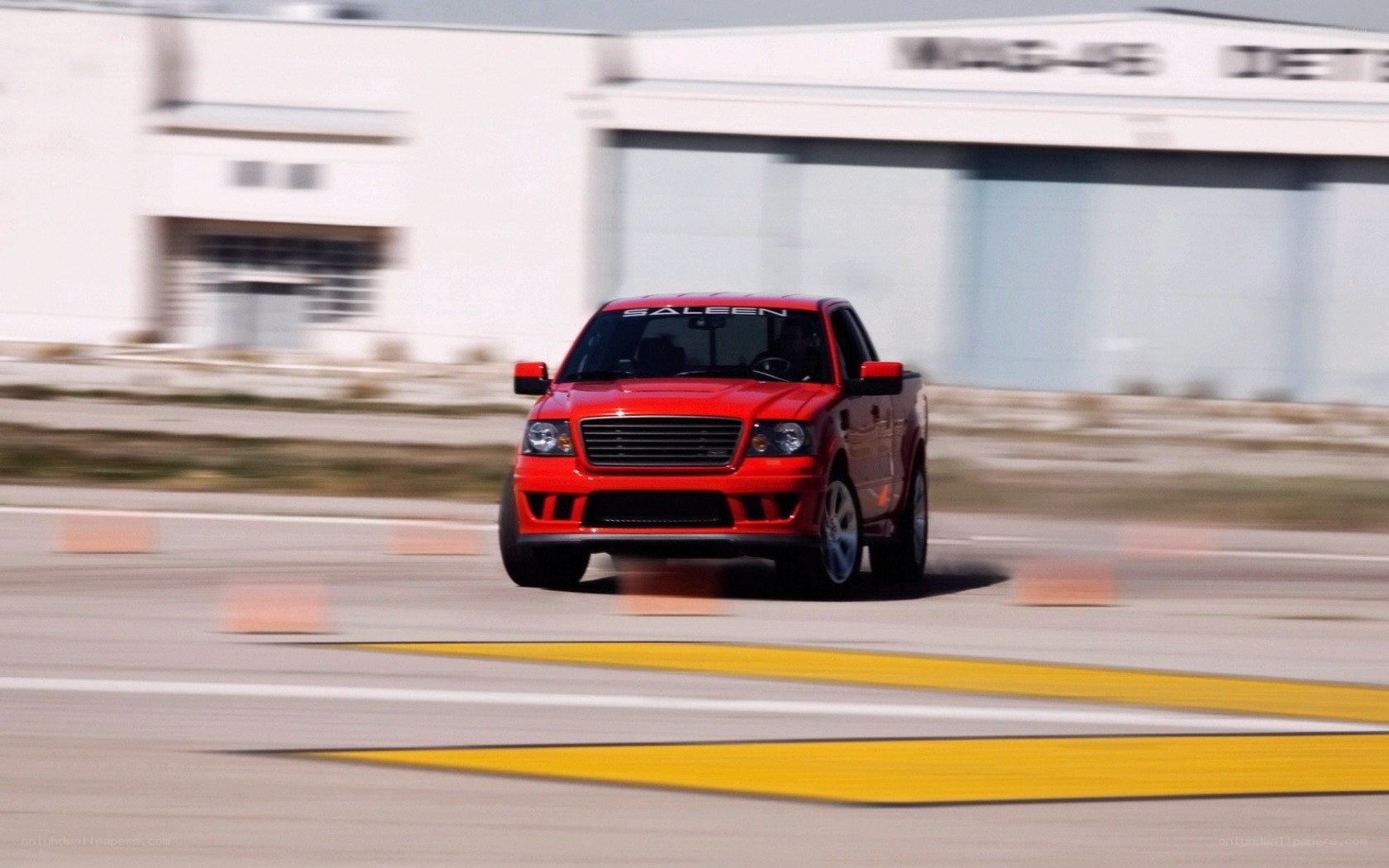 Red pickup truck on a track