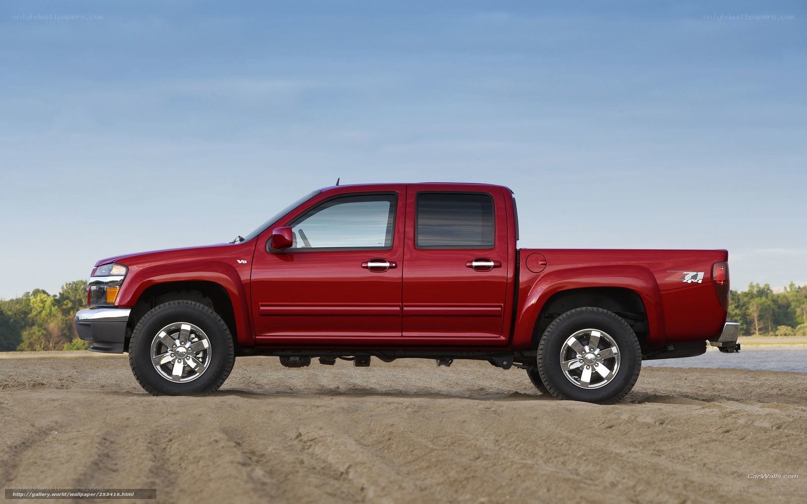 Red pickup truck on beach