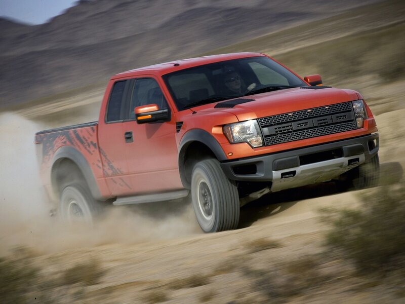 red pickup truck on dirt road