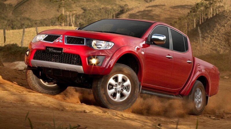 Red pickup truck on dirt road