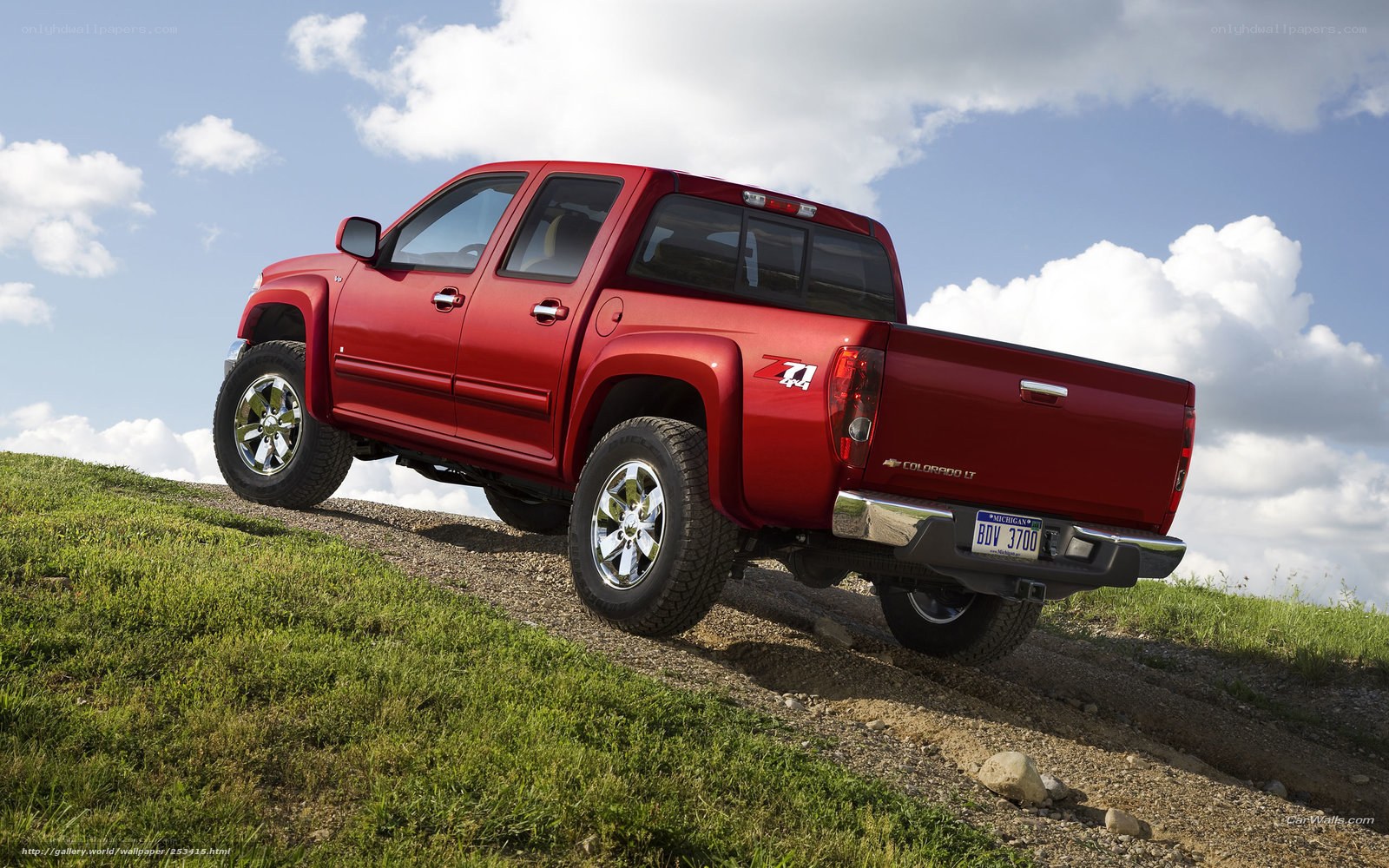 Red pickup truck on hill