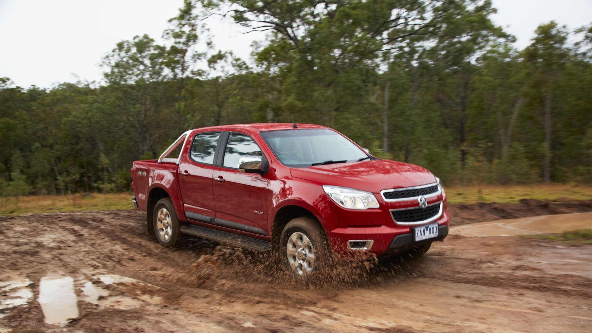 red pickup truck on muddy road