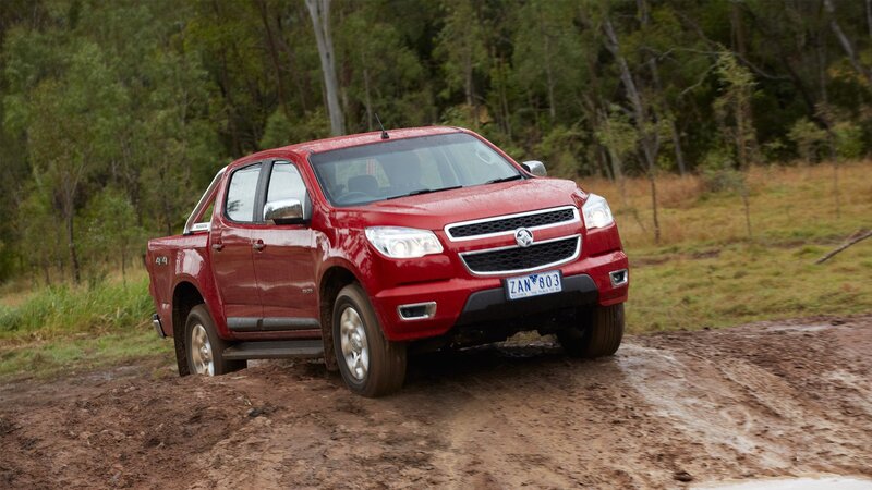 Red pickup truck on muddy terrain