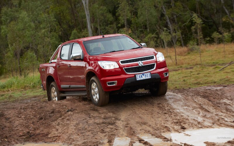 Red pickup truck on muddy terrain