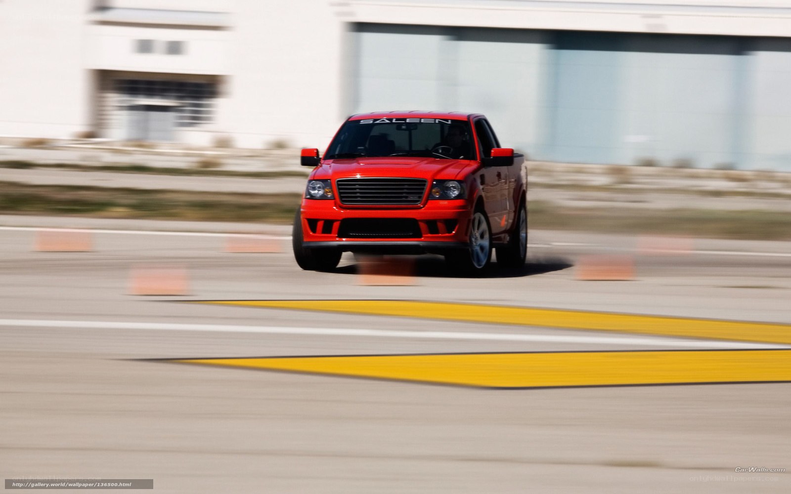 red pickup truck on track