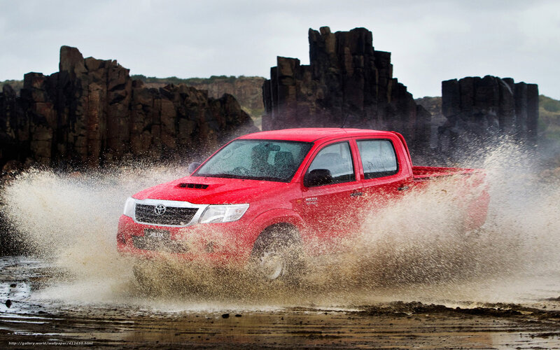 Red pickup truck splashing water