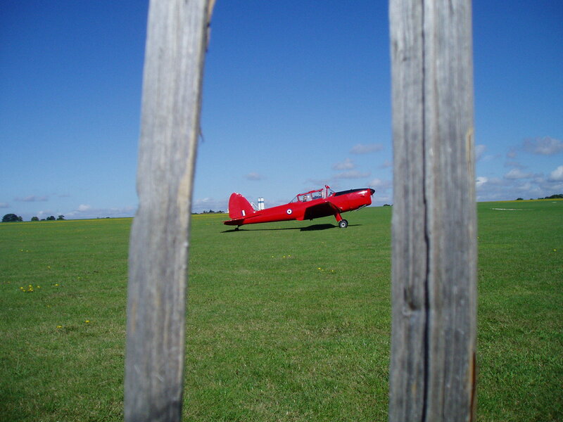 Red plane on grass field