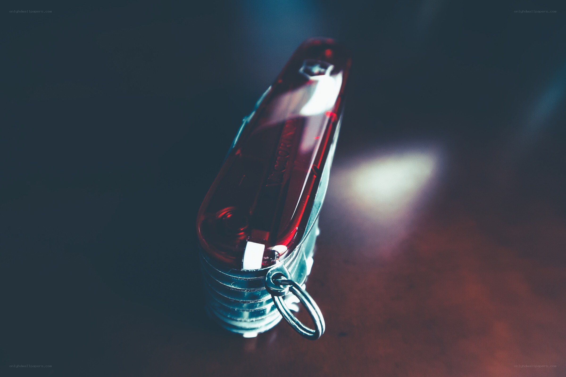 Red pocket knife on dark surface