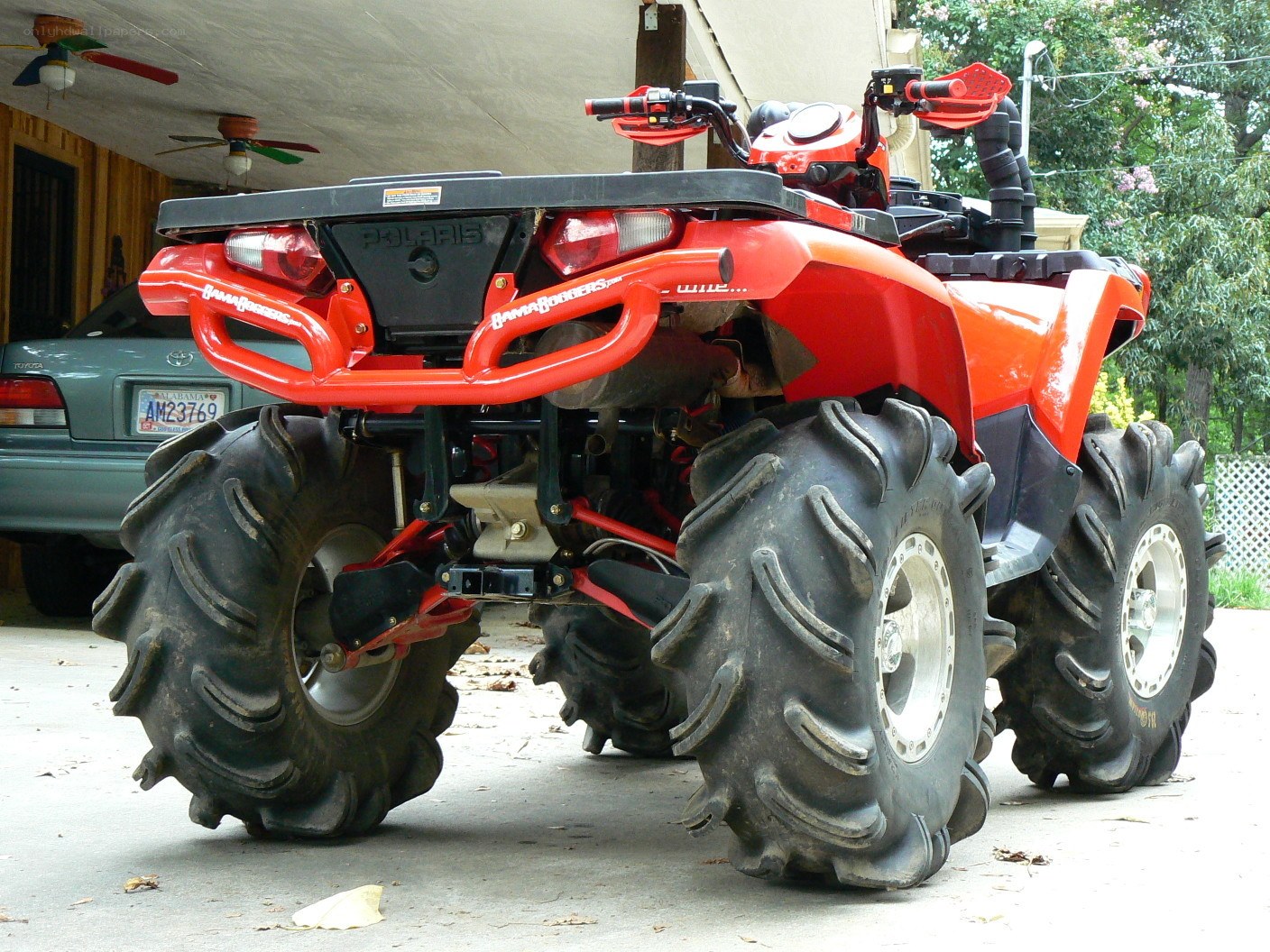 Red Polaris ATV parked outside