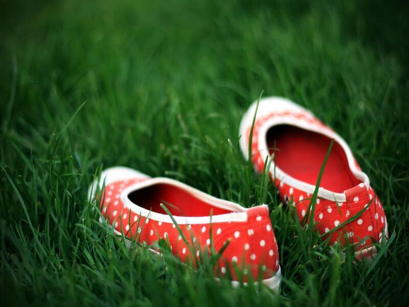 Red polka dot shoes on grass