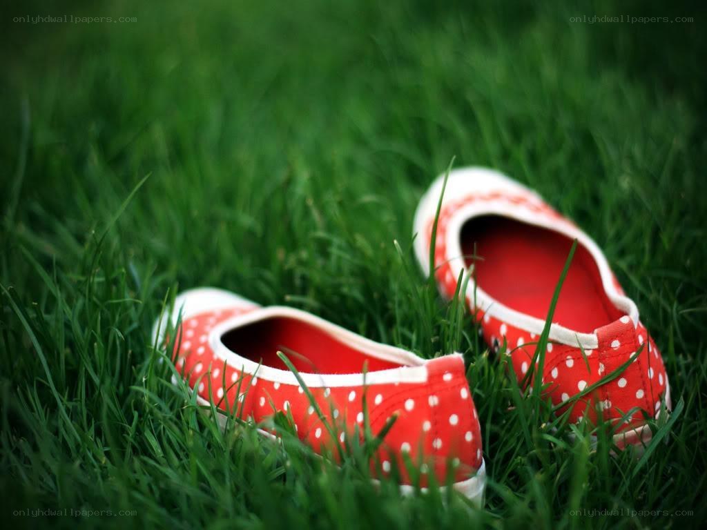 Red polka dot shoes on grass