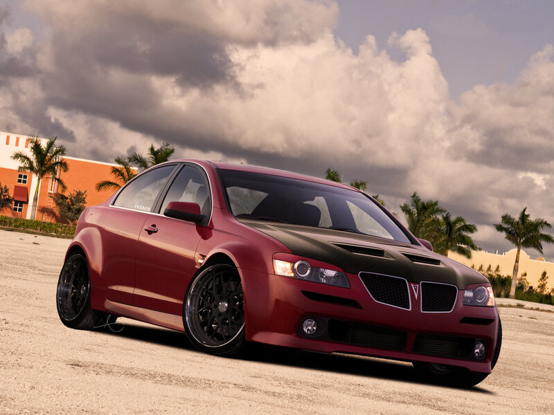 red pontiac g8 on a dirt lot