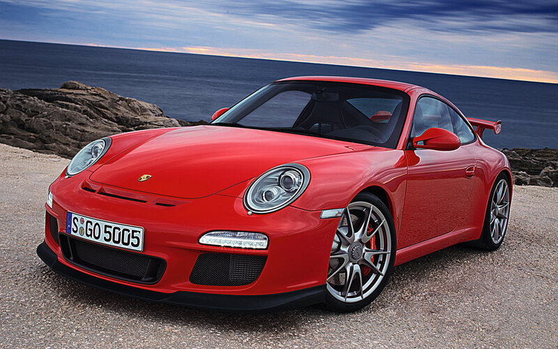 Red Porsche 911 GT3 on coastal road