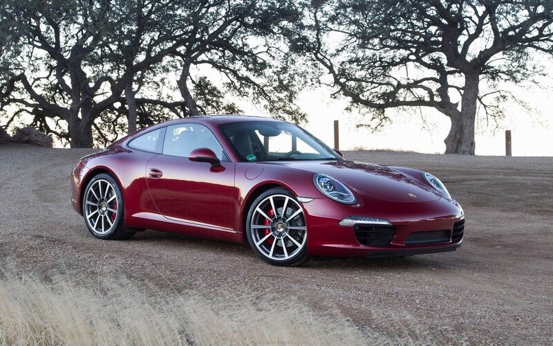 Red Porsche 911 on a dirt road