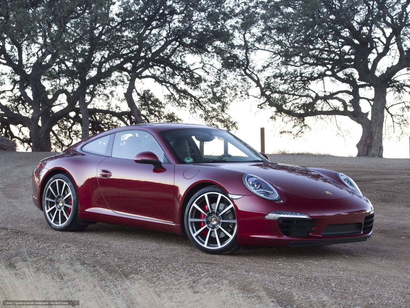 Red Porsche 911 on a gravel road