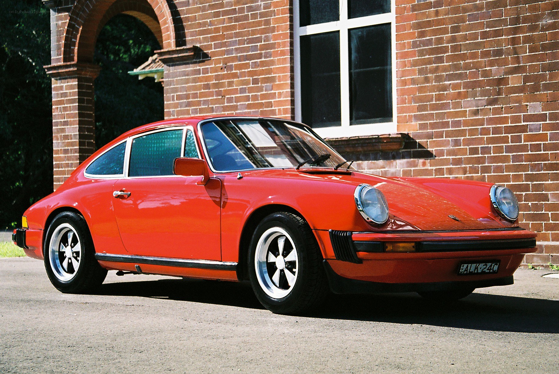 Red Porsche 911 parked outside
