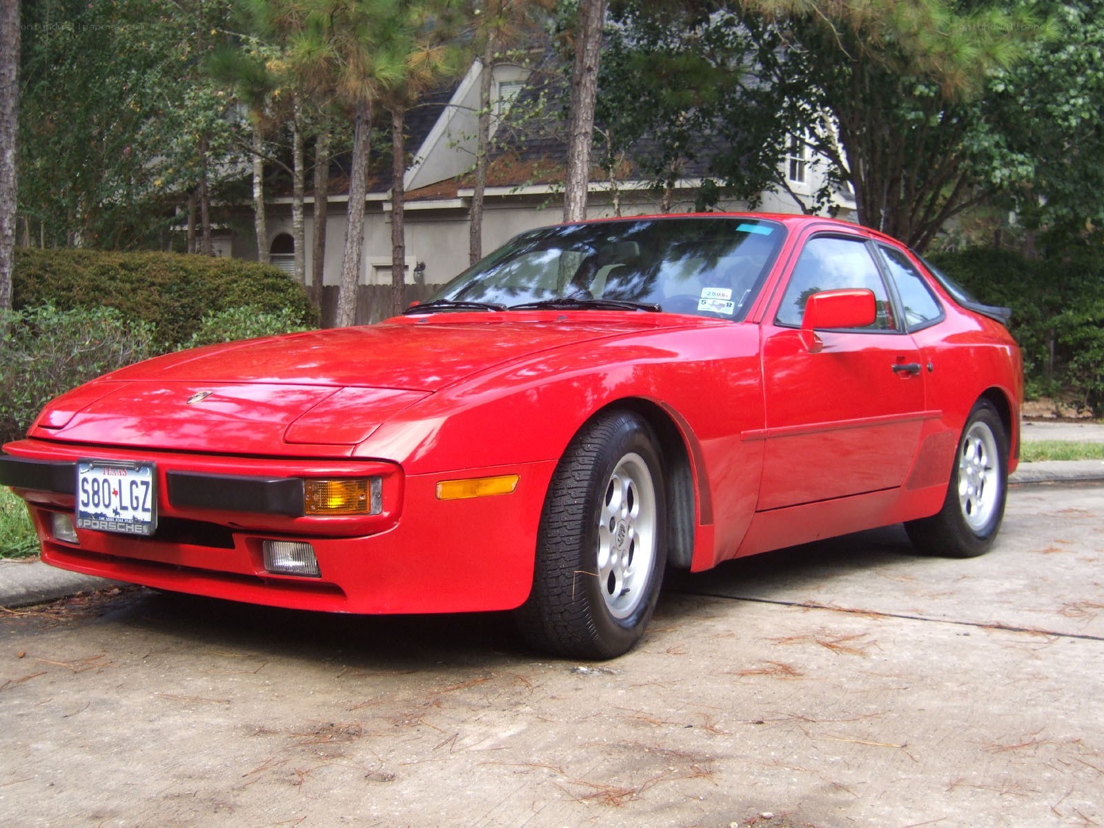 Red Porsche 944 parked outside