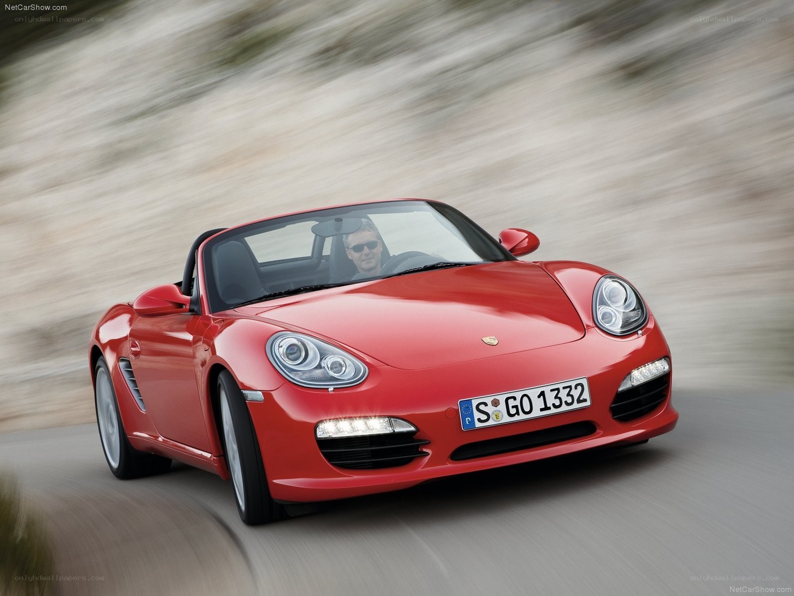 Red Porsche Boxster in motion