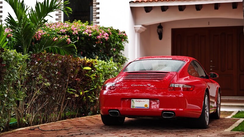 Red Porsche Carrera parked outside