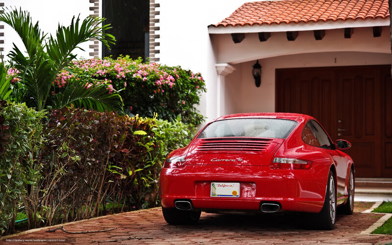 Red Porsche Carrera parked outside