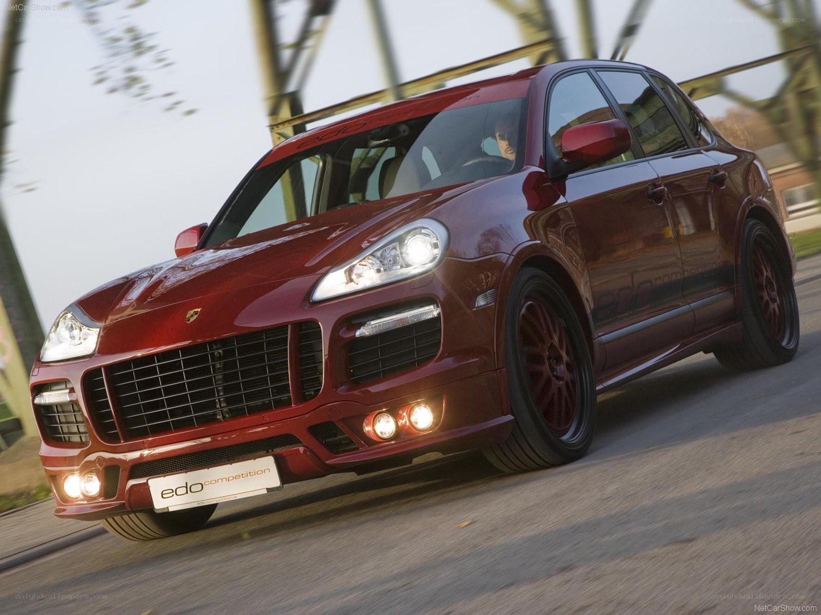 Red Porsche Cayenne in motion