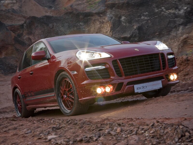 Red Porsche Cayenne in rugged terrain
