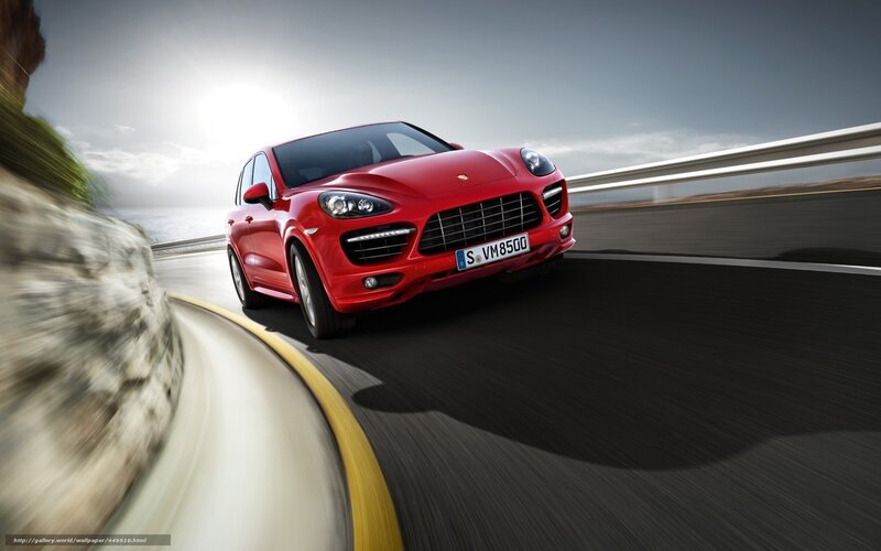 Red Porsche Cayenne on coastal road