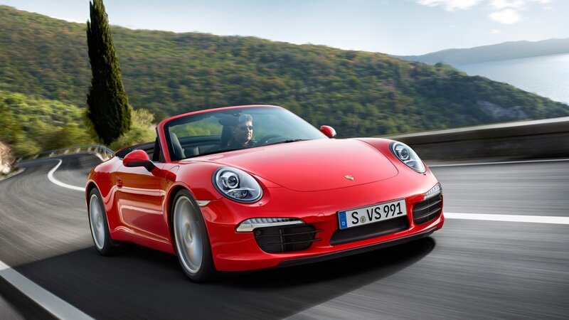 Red Porsche convertible on coastal road