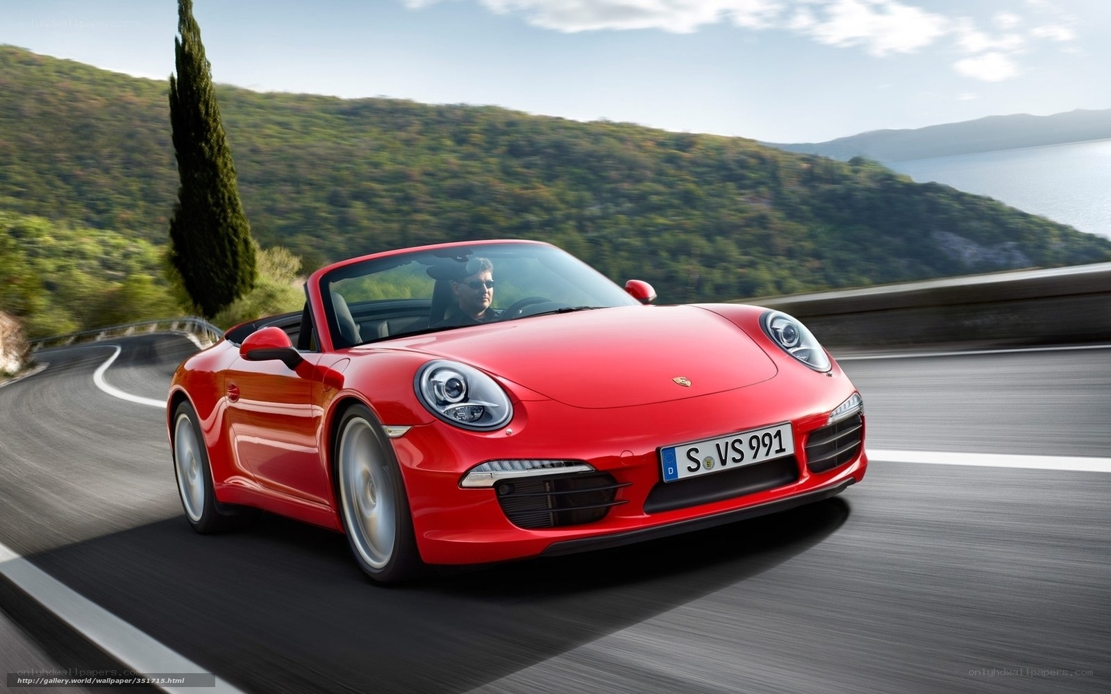 Red Porsche convertible on coastal road